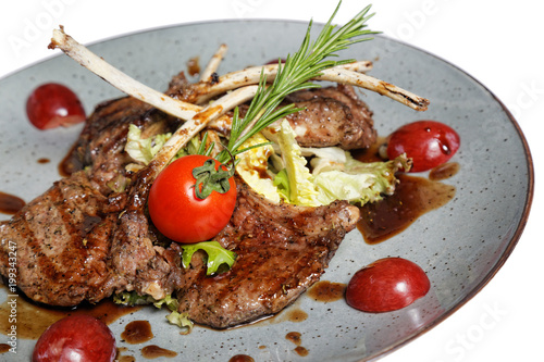 grilled meat on bone with garnish of vegetables