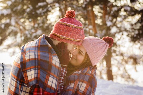 loving young couple in winter under a ruffled embrace