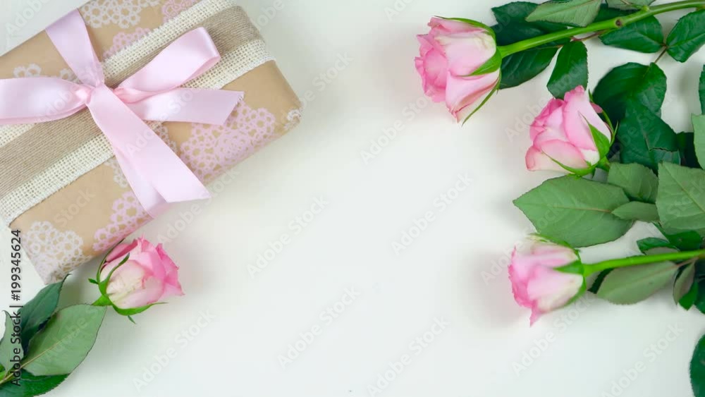 Happy Mother's Day overhead with gift and pink roses on white wood table background time lapse. Happy Mother's Day overhead with gift and pink roses on white wood table background time lapse.