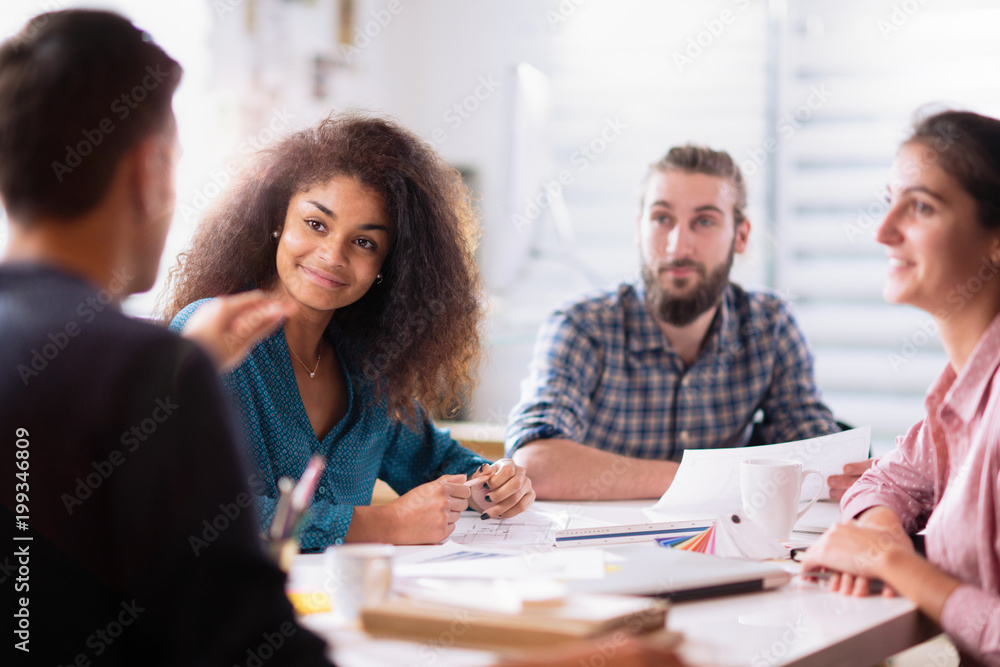 At office. A young man leads a multiethnic working group At office. A young man leads a multiethnic working group