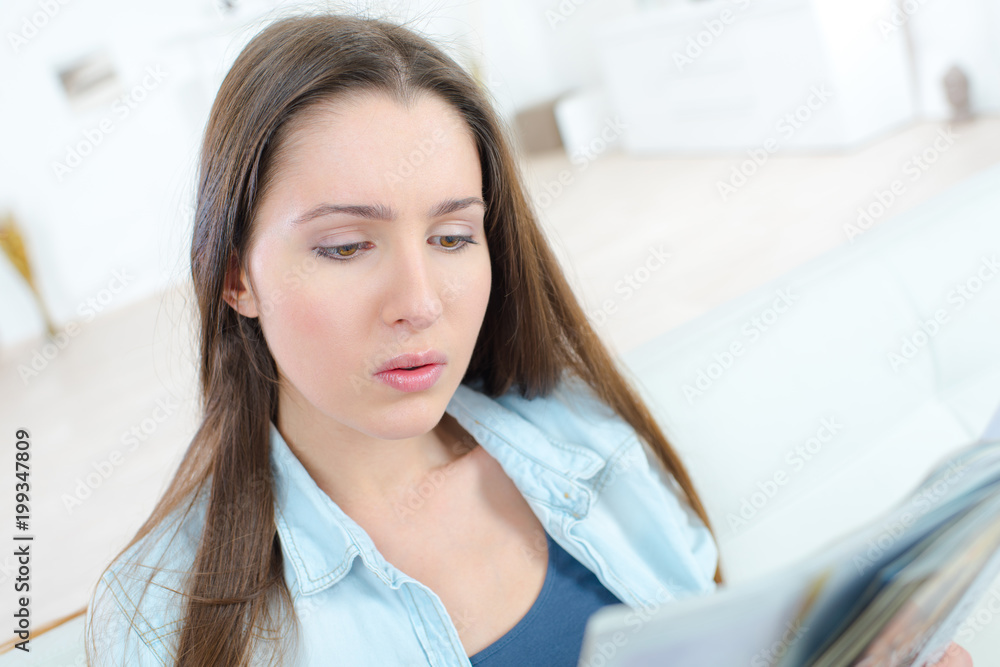 young woman reading magazine while chill out at home young woman reading magazine while chill out at home