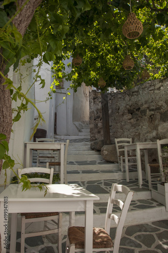 Outdoor part of taverna on the streets of Naxos town at Naxos island in Greece