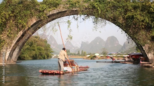 man rafting on bamboo boat