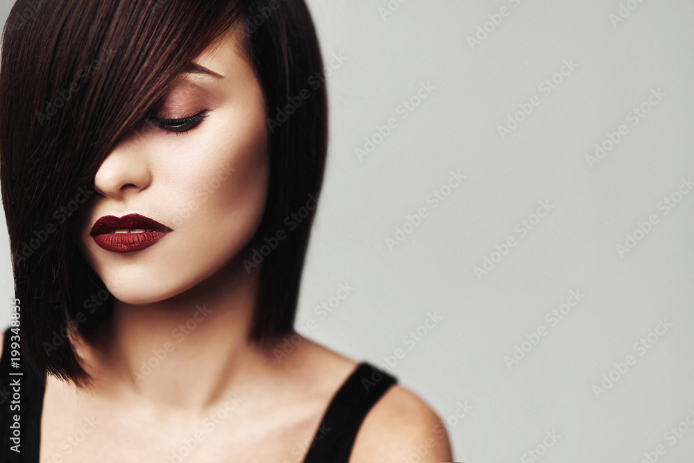 Model with perfect long glossy brown hair. Close-up Bob haircut portrait Model with perfect long glossy brown hair. Close-up Bob haircut portrait