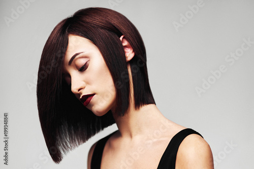 Model with perfect long glossy brown hair. Close-up Bob haircut portrait