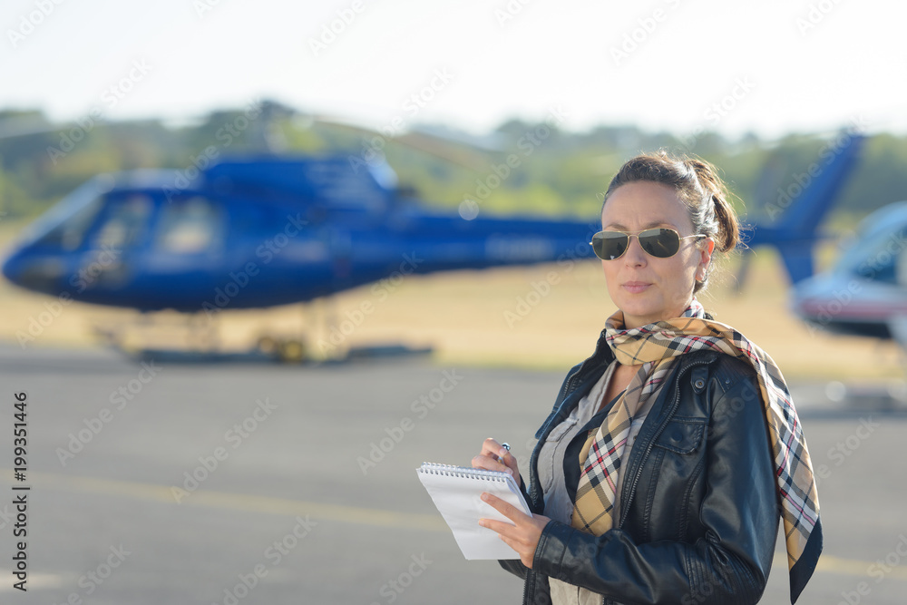 pretty pilot woman on helicopter background