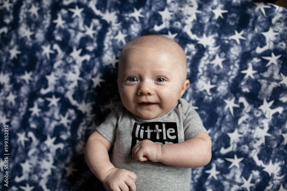Overhead portrait of cute baby boy smiling while lying on mattress at home Overhead portrait of cute baby boy smiling while lying on mattress at home