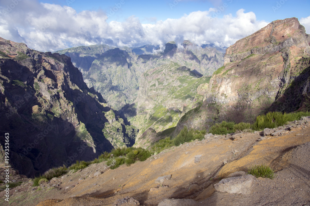Pico do Arieiro hiking trail, amazing magic landscape with incredible views, rocks and mist, view of the valley between rocks