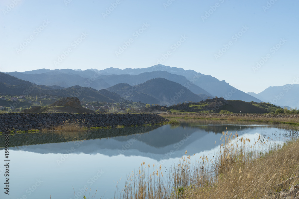 irrigation channel,spring season and mountain range