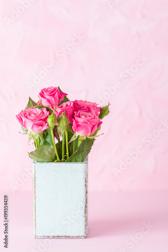 Pink pastel vertical banner with bouquet of pink roses in retro shabby chic vase.