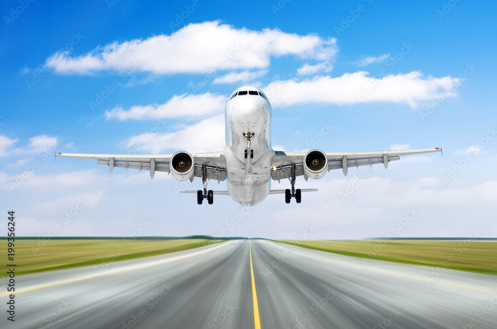 Fototapeta premium Airplane aircraft flying departure landing speed motion on a runway in the good weather with cumulus clouds sky day.