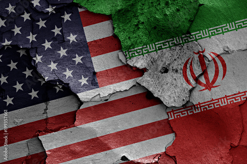 flags of USA and Iran painted on cracked wall