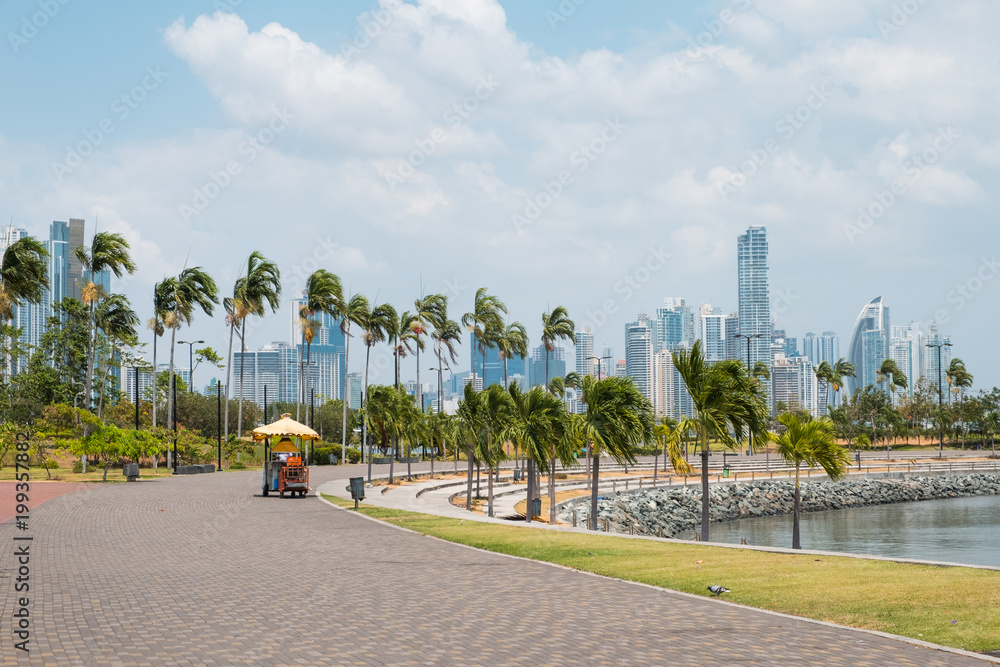 Sidewalk at public park with city skyline at coast promenade in Panama City -