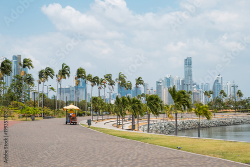 Sidewalk at public park with city skyline at coast promenade in Panama City - photo