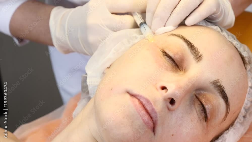 Cosmetician in gloves making face lifting injection to area around eyes. female client gets facial beauty procedure in healthcare clinic. liquid thread injection. Botox. collagen Cosmetician in gloves making face lifting injection to area around eyes. female client gets facial beauty procedure in healthcare clinic. liquid thread injection. Botox. collagen