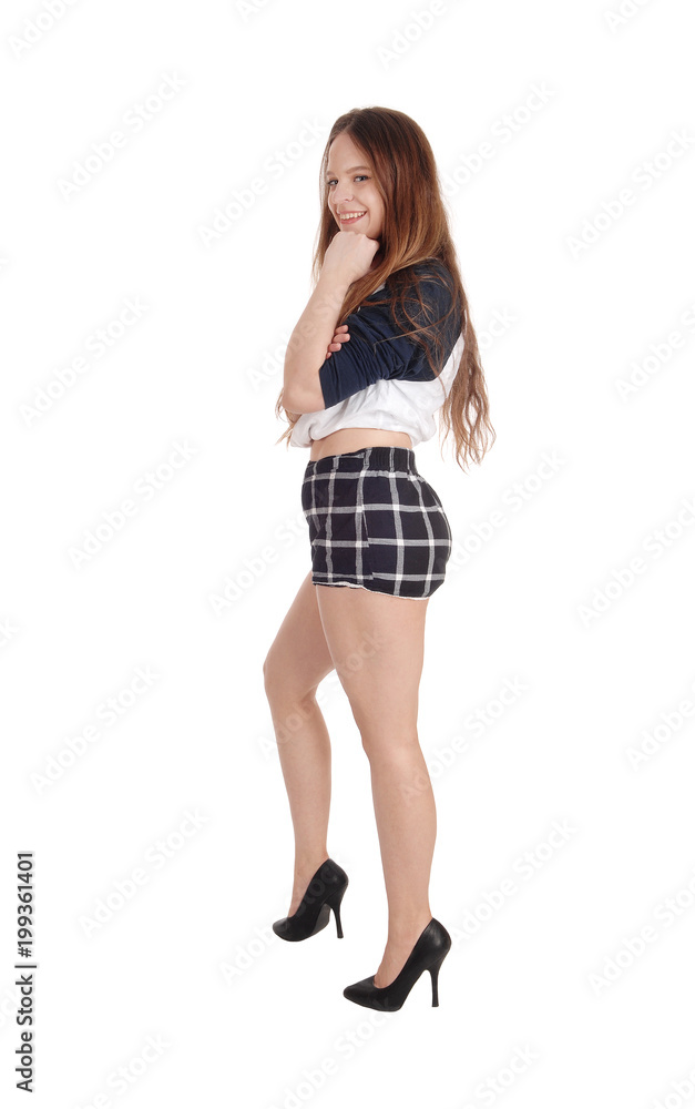 A beautiful woman standing in checkered shorts A beautiful woman standing in checkered shorts