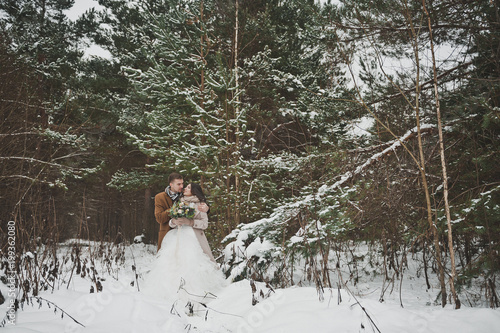 A walk of a young couple in a snowy forest 903.