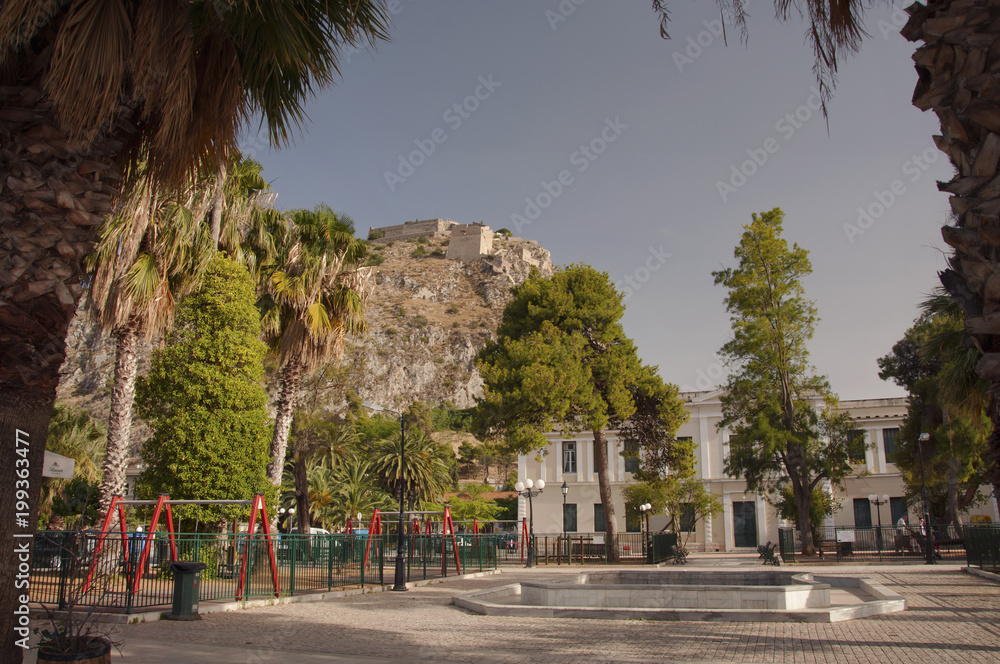 Obraz premium View over Palamidi fortress from the square near park in the old part of Nafplio town in Greece