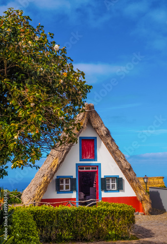 Traditional triangular house in Santana village (vertical photography), in Madeira island of Portugal
