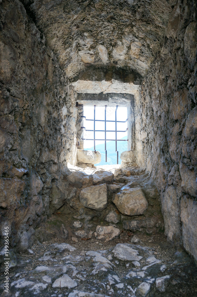 Cage window in ancient tower in Italy