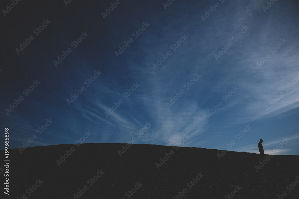 Silhouette man on land against sky during dusk at Death Valley National Park Silhouette man on land against sky during dusk at Death Valley National Park