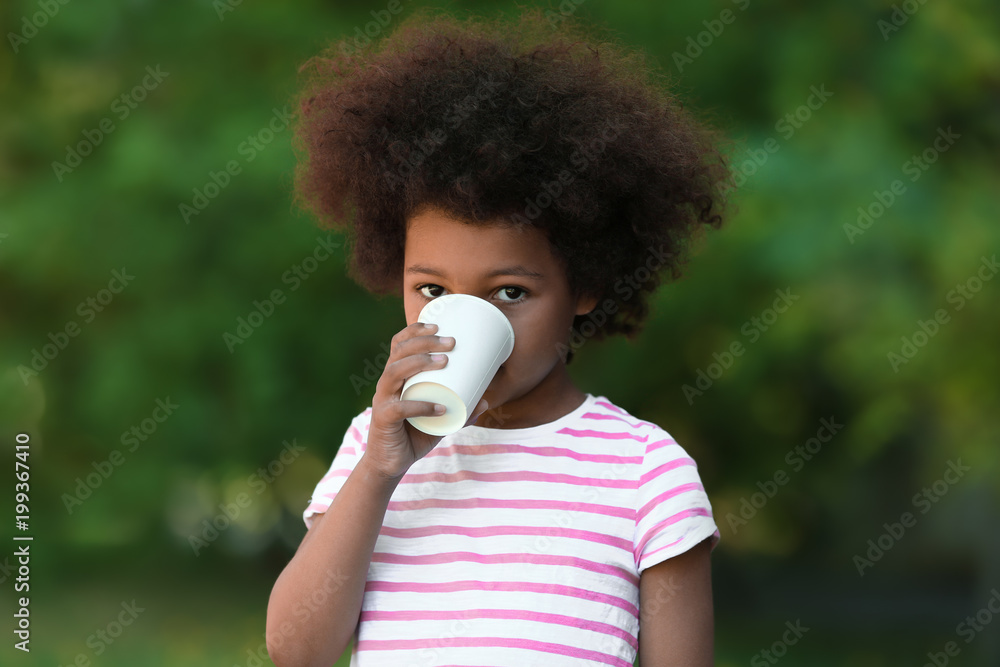 African American child drinking water outdoors. Water scarcity concept African American child drinking water outdoors. Water scarcity concept