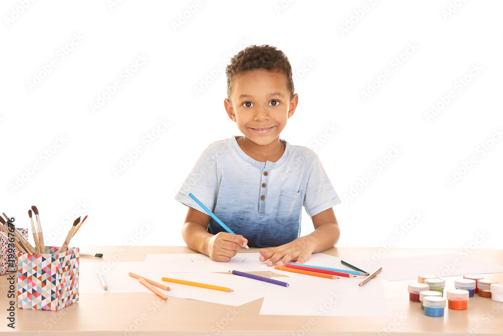 Fototapeta premium Little African-American boy drawing against white background