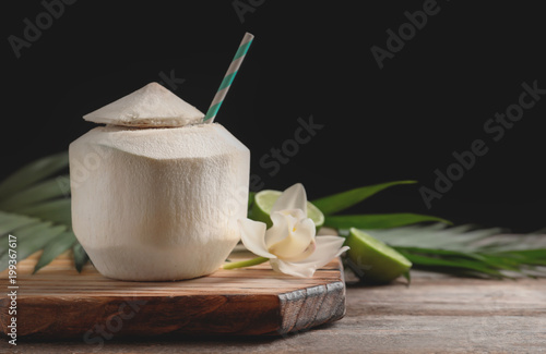 Fresh coconut drink in nut on wooden board