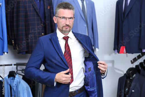 Handsome man trying on suit...