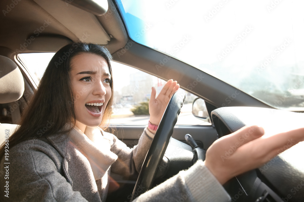 Young woman in car during traffic jam Young woman in car during traffic jam