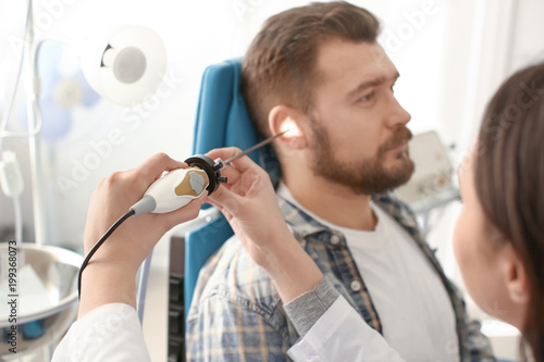 Otolaryngologist examining ...