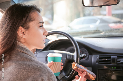 Young woman having snack in...