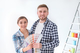 Young couple with color palette on white background