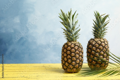 Fresh pineapples on wooden table