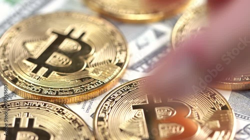 Bitcoins on dollar banknotes background, closeup