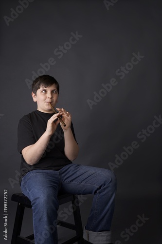 youth or young boy learning tin whistle or  irish penny whistle