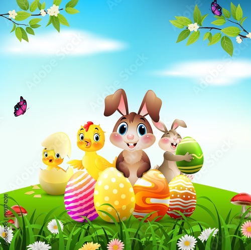 Easter Bunny with baby chicks and duckling on a meadow
