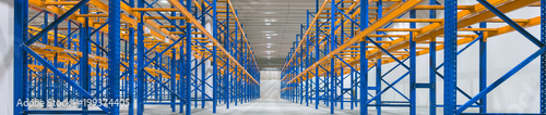 Wide image of empty shelves in logistics warehouse