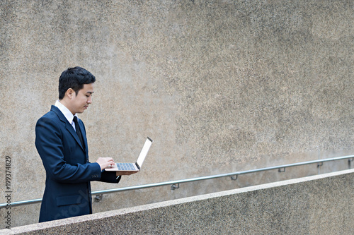 businessman uses laptop outdoor