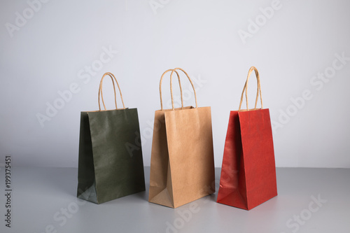 some colorful paper present bag with kraft bag