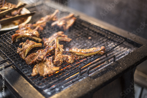 closeup of some meat skewers being grilled in a barbecue