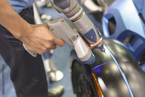 The 3D scan arm for measuring the automotive parts. © Pixel_B