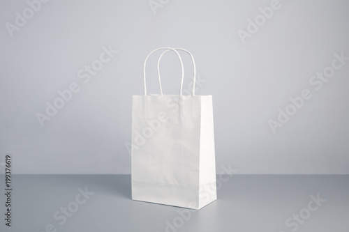 white color paper bag on table
