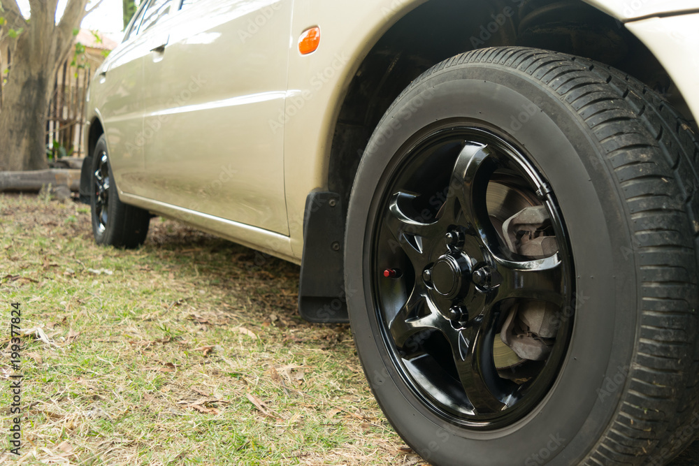 Black car wheel in retro style background