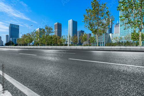 city empty traffic road with cityscape in background.