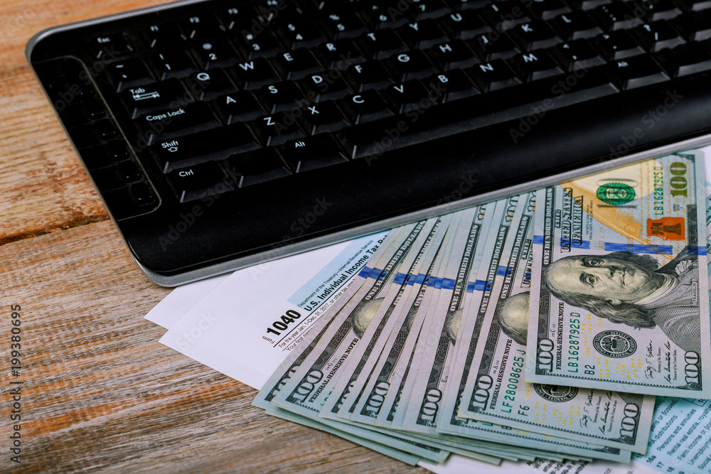1040 U.S. Individual Income Tax Return and banknote, finance concept 1040 U.S. Individual Income Tax Return and banknote, finance concept