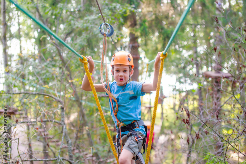 brave boy on a zip line. the concept of the overcoming challenge