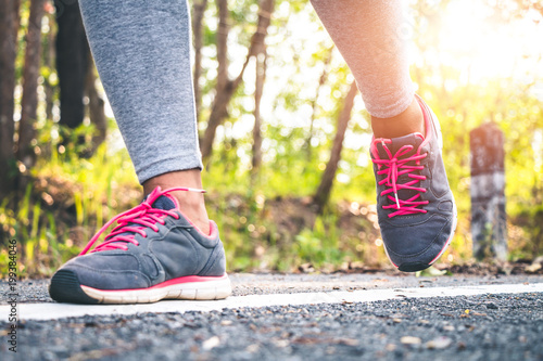 Women runner feet on road in workout wellness concept. © r_tee