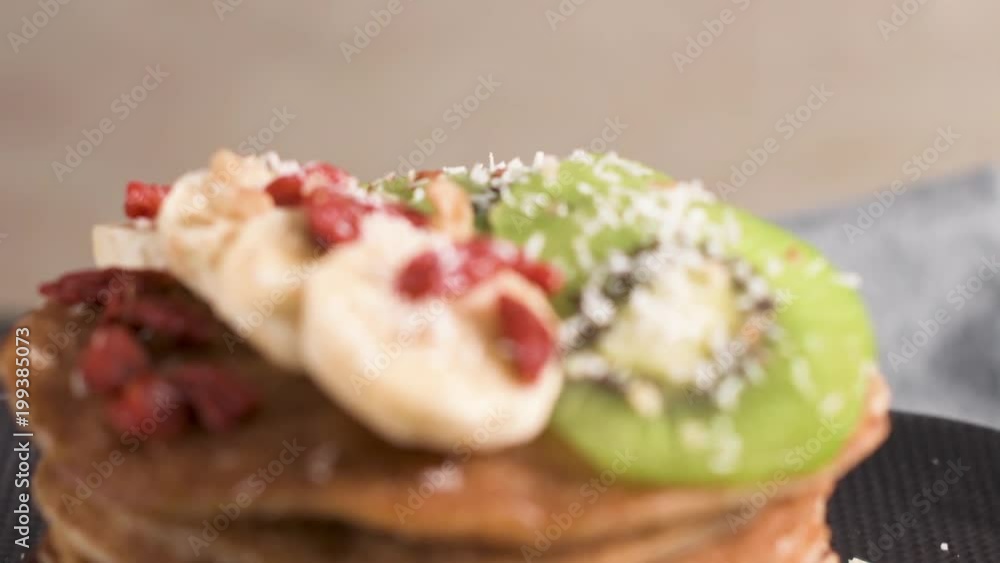 Healthy breakfast table, homemade pancakes with kiwi, banana, goji and walnuts. Healthy breakfast table, homemade pancakes with kiwi, banana, goji and walnuts.