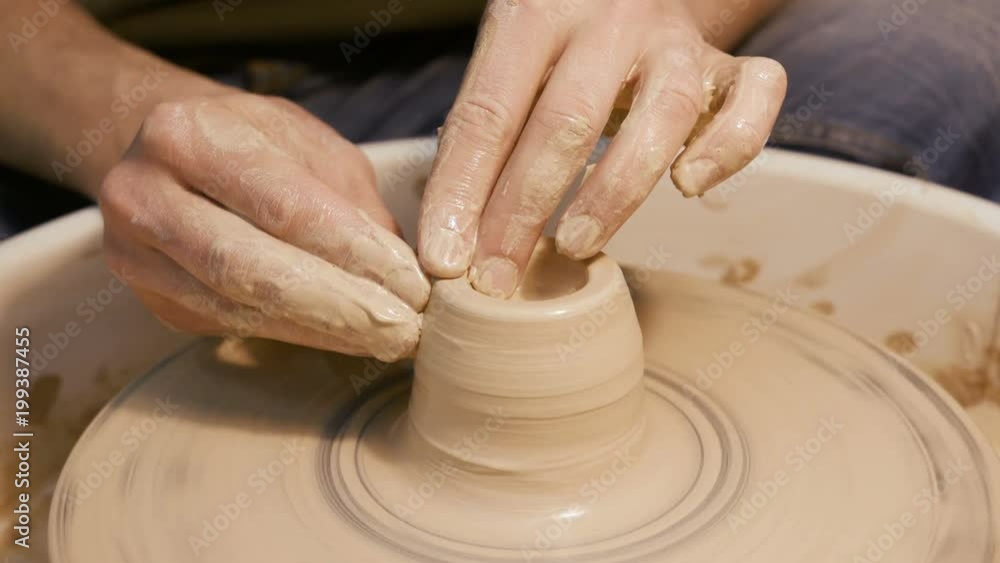 Handicraftsman create product on the circle potterswheel close up isolated. Artisan dexterity and skilfully sculpt traditional culture brown vase or cup. The creativity leisure, creating job of artist